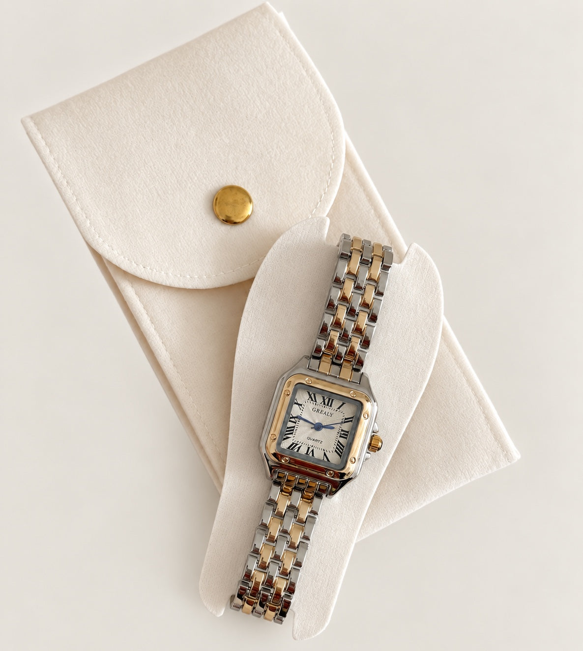 Two-tone rectangular quartz wristwatch displayed in its white presentation case